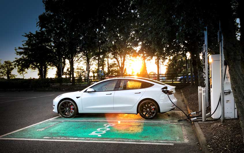 Tesla Model 3 Charging at Sunset