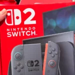 Man holding brand new Nintendo Switch 2 box.