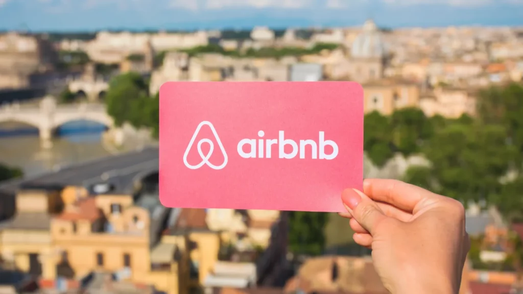 Person holding Airbnb logo