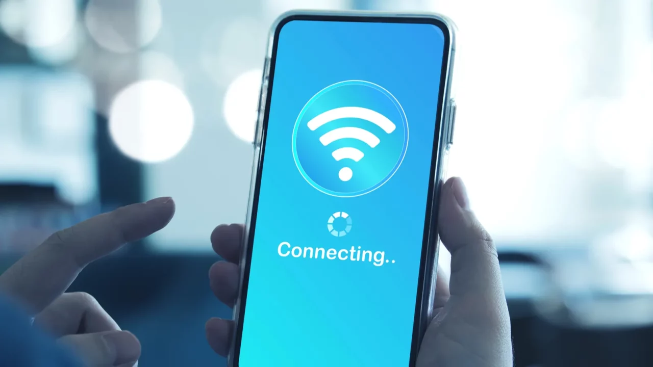 https://automatedhome.com/wp-content/uploads/2025/09/man-using-smartphone-connects-to-wireless-fidelity-wi-fi-internet-on-e1757069143330.webp