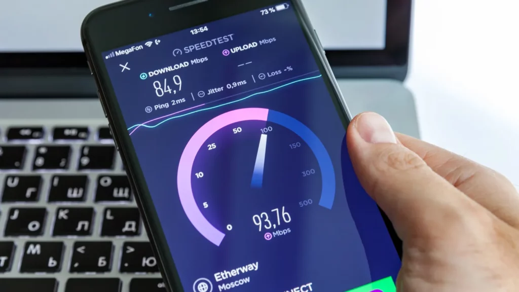 A person holding smartphone that monitors internet speed