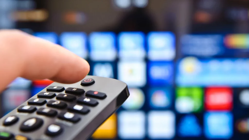 A man using remote to control TV.