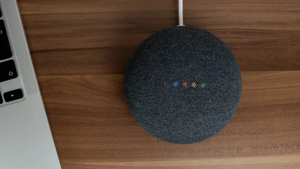 Google home smart speaker placed on a wooden table