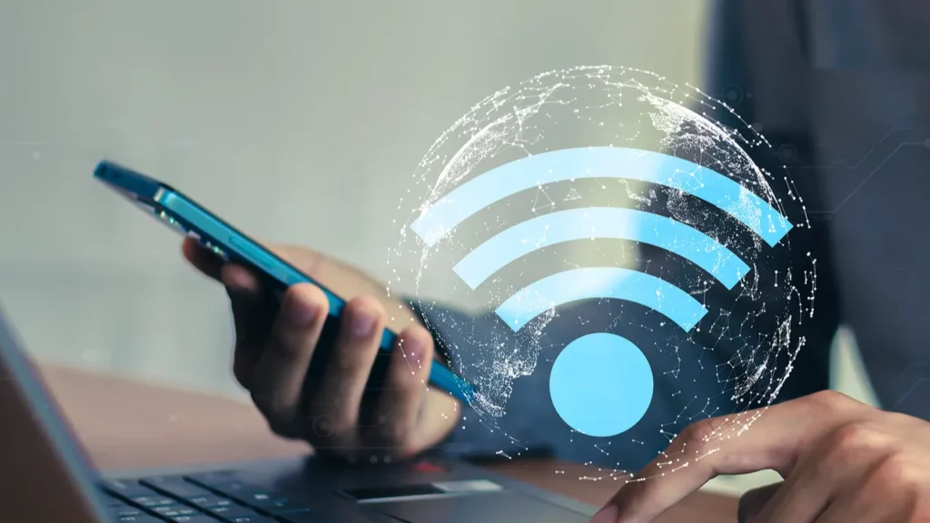 Person using a smartphone with a Wi-Fi icon overlay.