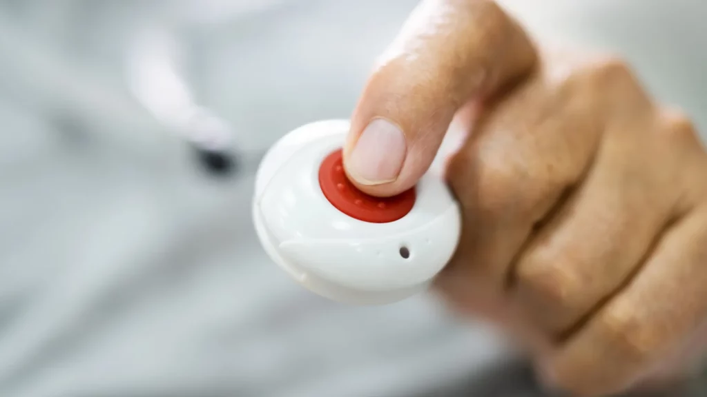 A senior man holding alarm.