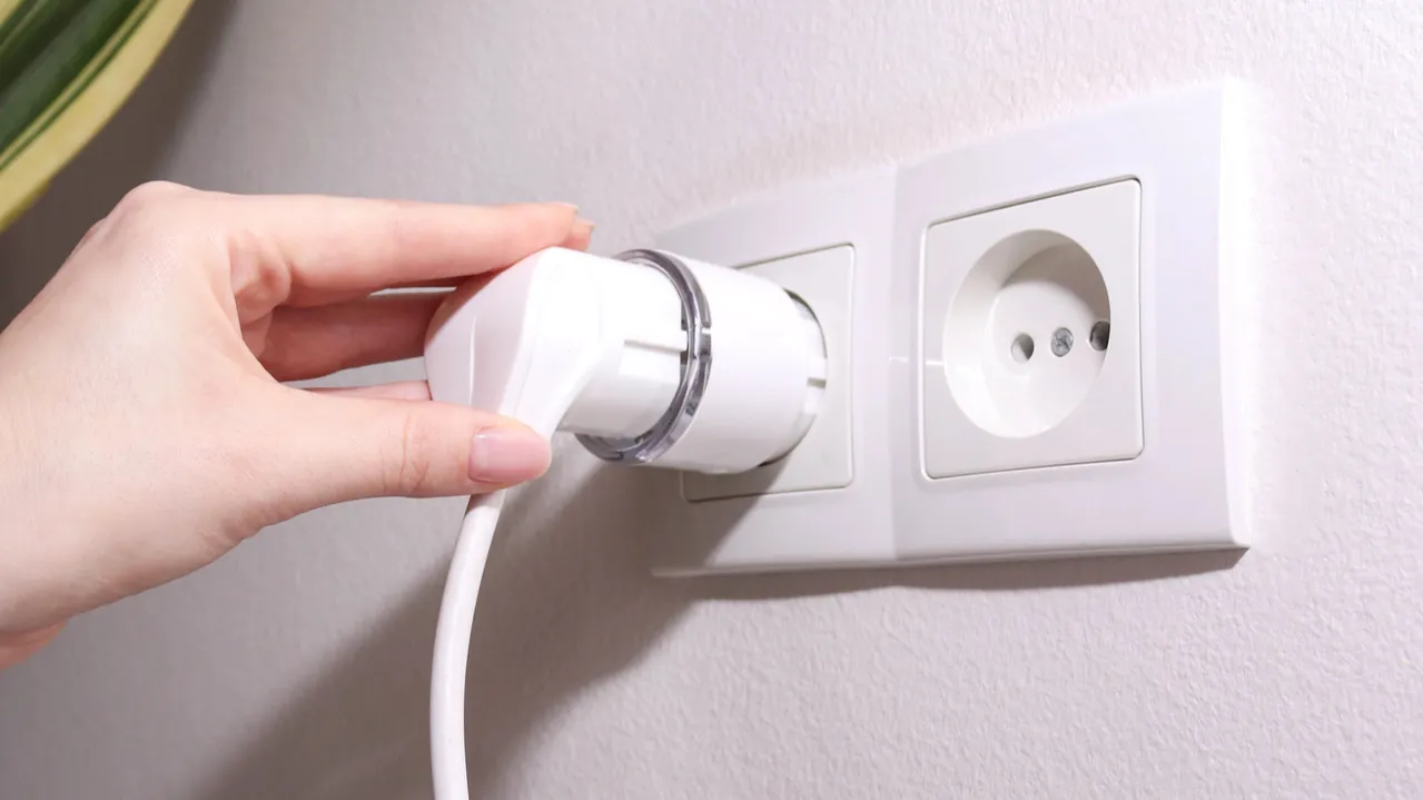 woman plugging cable into smart plug