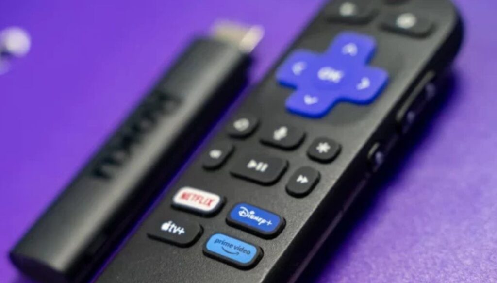 Roku Streaming Stick with remote on a purple background. 
