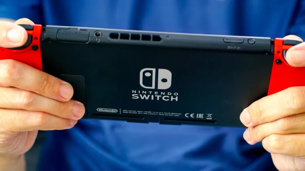 Hands holding a Nintendo Switch.