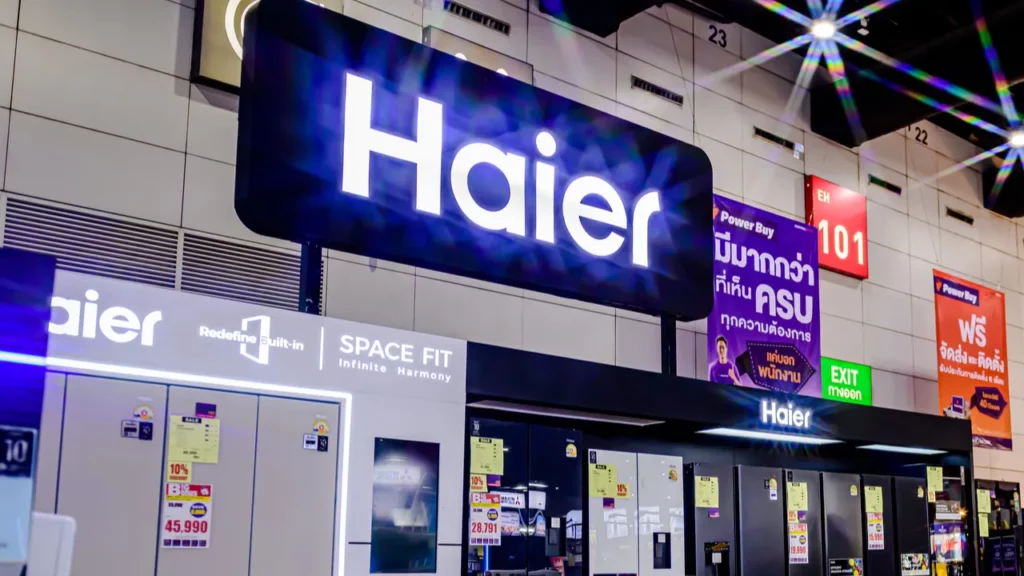 Haier logo above refrigerators in store.