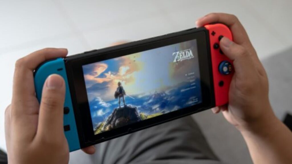 Hands holding a Nintendo Switch playing Zelda.