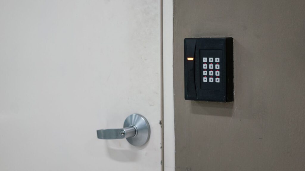 The digital locking keypad with number dial that installed on the wall closed to the locked door. 